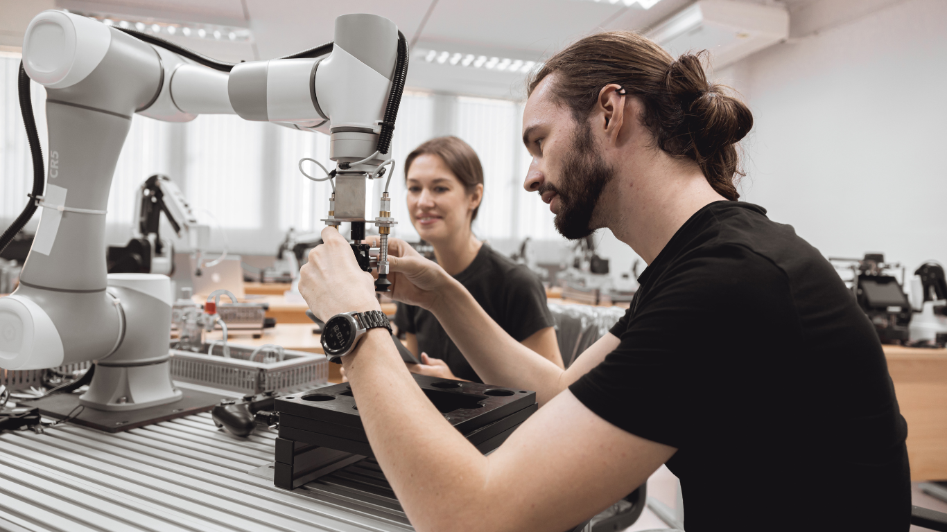 skills in demand visa, a man and woman working on a machine